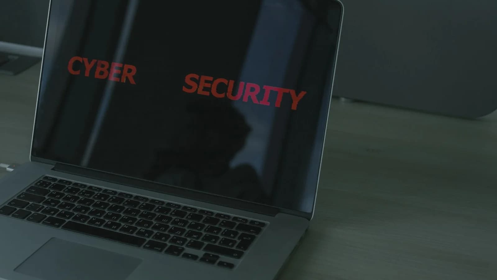 Close-up of a laptop displaying cybersecurity text, emphasizing digital security themes.