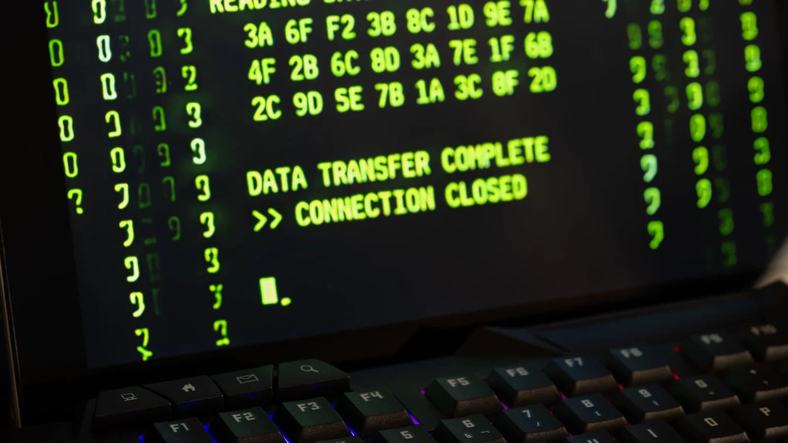 Data transfer complete message displayed on a computer monitor with a keyboard underneath.