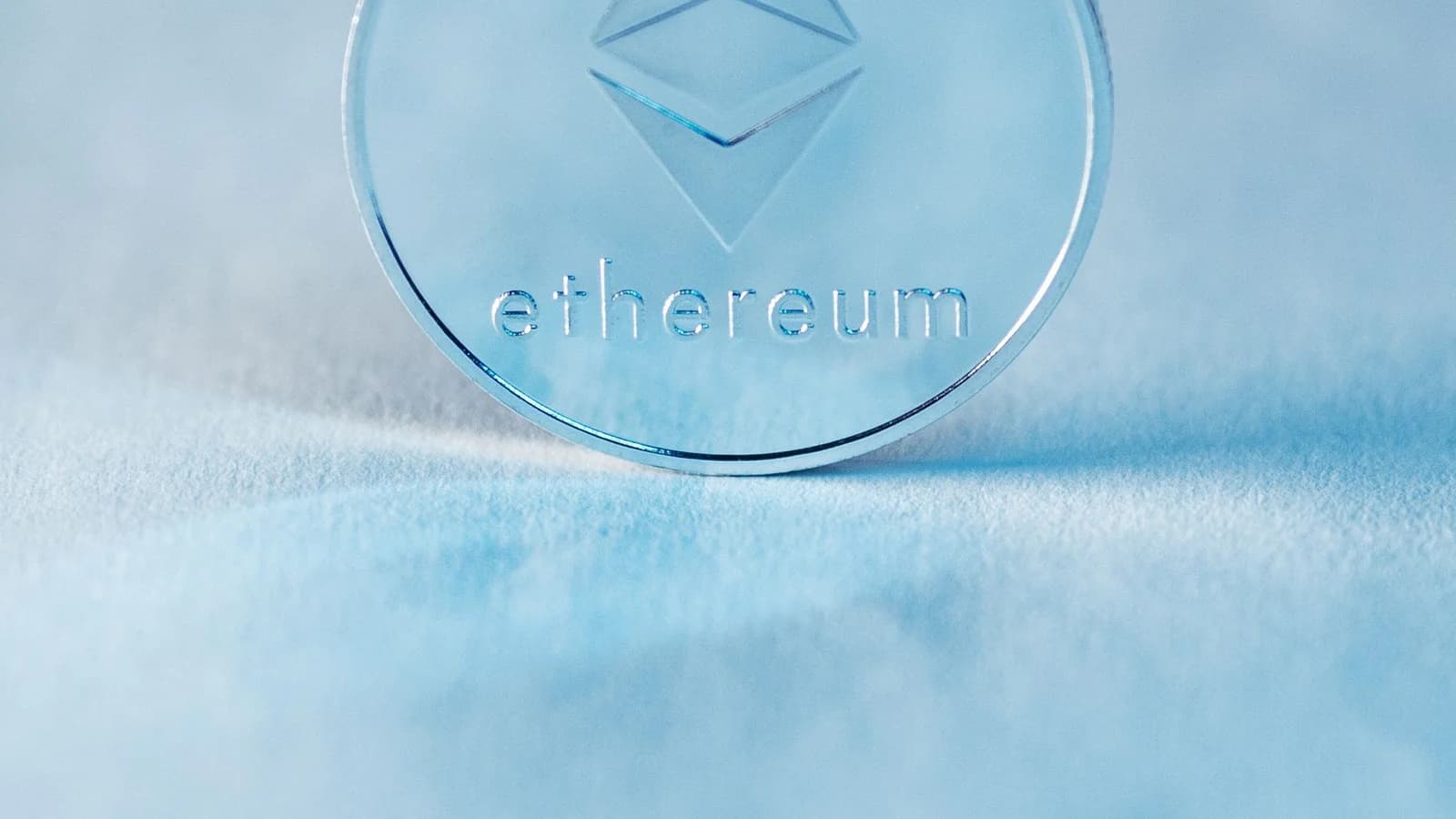 Ethereum coin against a soft blue background