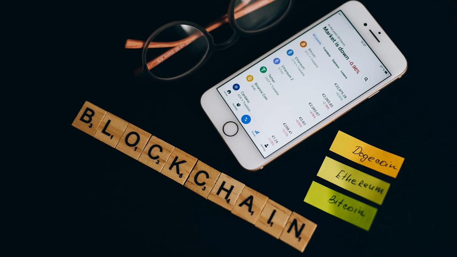 Smartphone displaying cryptocurrency market data alongside blockchain concept elements.