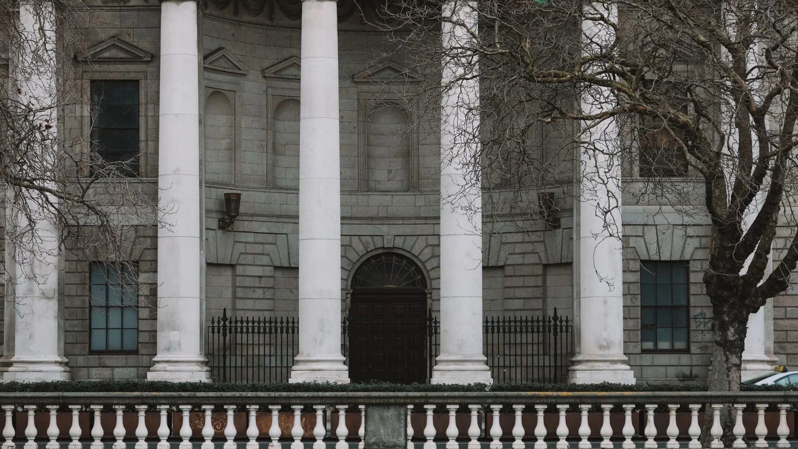 Elegant neoclassical facade of Dublin's Four Courts with iconic white columns.