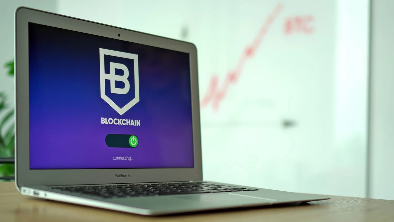 MacBook Air showing a blockchain application interface in an office setting.